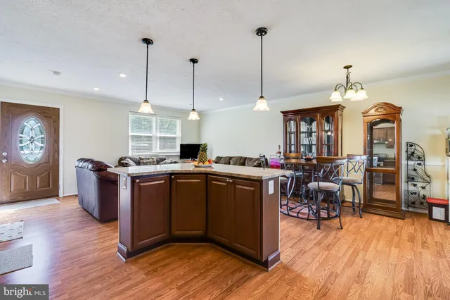 a view of living room with furniture and wooden floor
