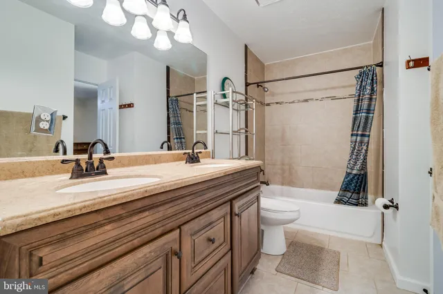 a bathroom with a double vanity sink mirror double and toilet