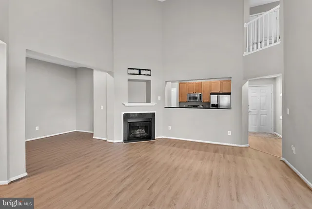 a view of a livingroom with an empty space and a fireplace