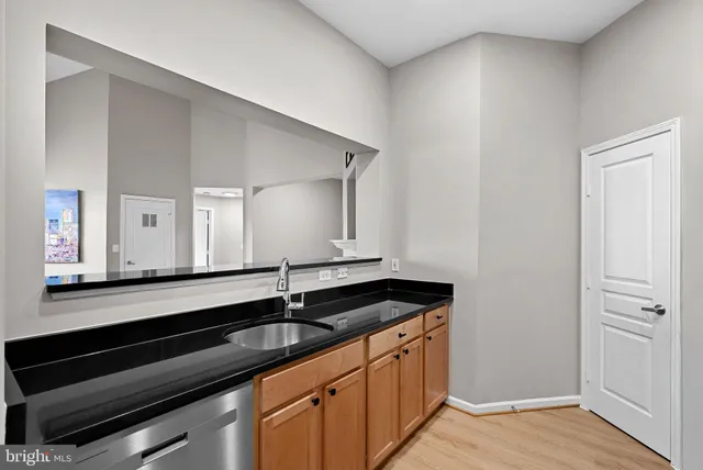 a kitchen with stainless steel appliances a sink stove and refrigerator