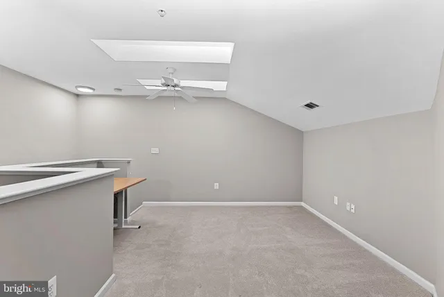 a view of a room with shelves and wooden floor