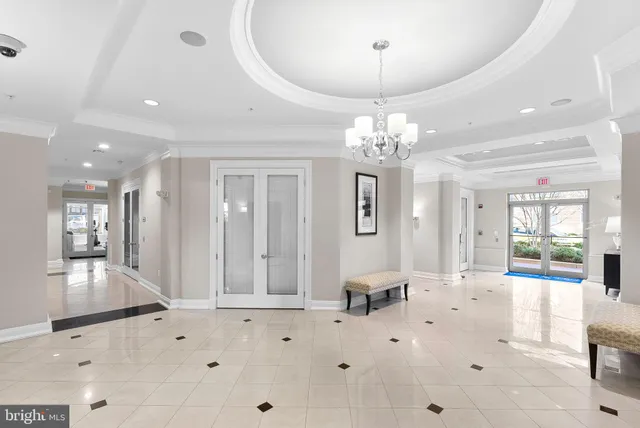 a view of hallway with furniture and wooden floor