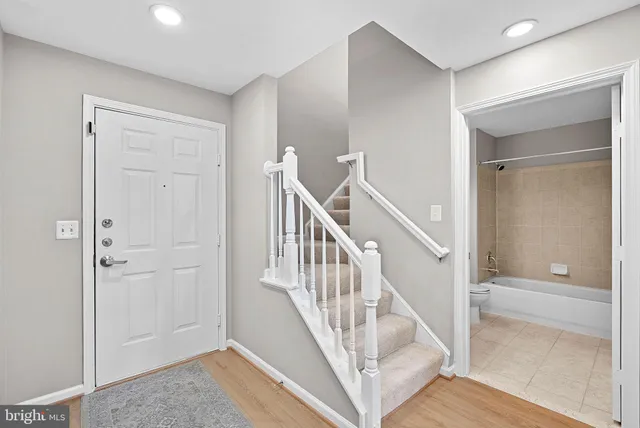 a living room with furniture a fireplace and a potted plant