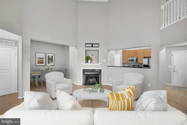 a view of a livingroom with wooden floor and a fireplace