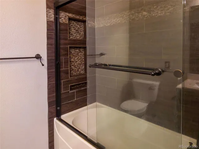 a bathroom with a shower and toilet