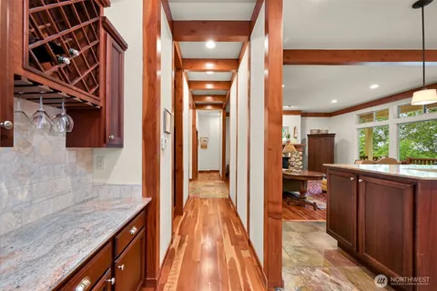 a view of a hallway with wooden floor and entryway