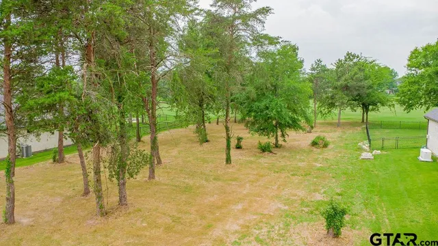 a swimming pool with trees in the background
