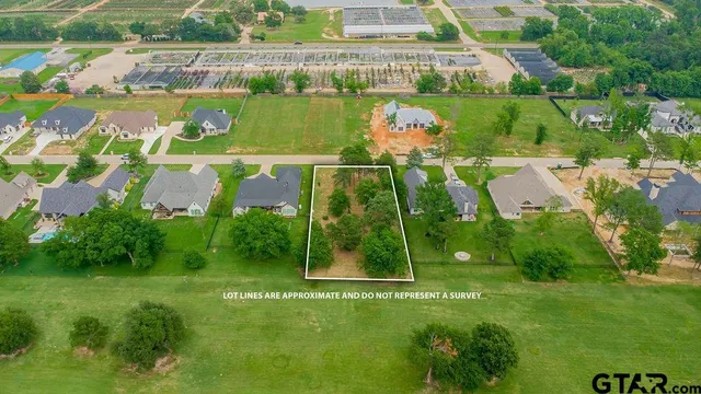 an aerial view of a houses with a yard