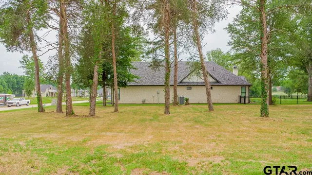 a backyard of a house with table and chairs