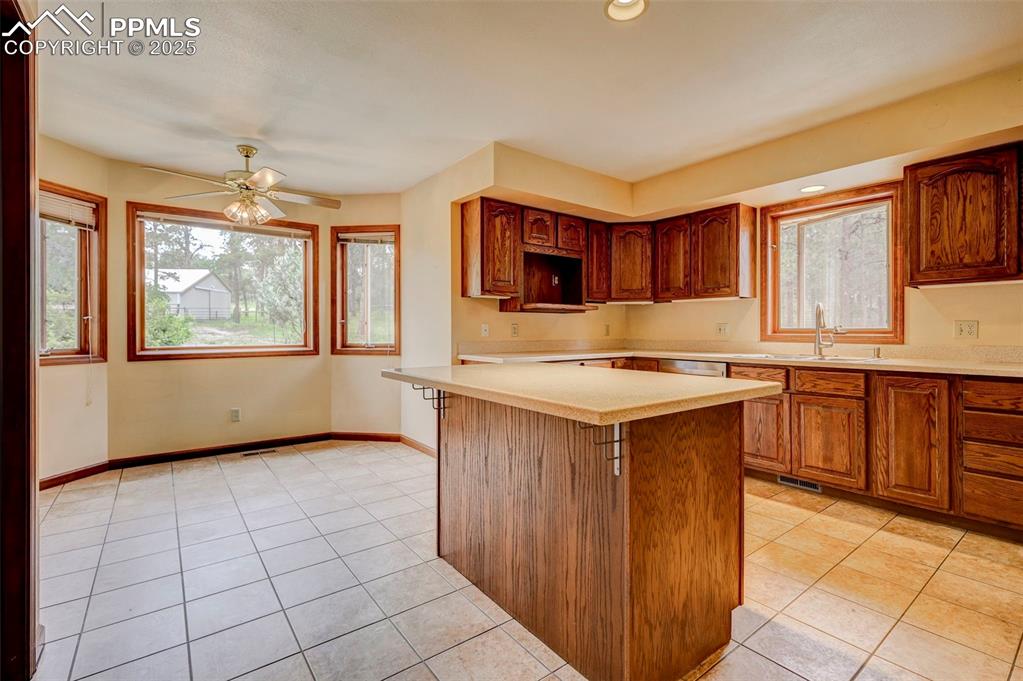 6290 Old Ranch Road Colorado Springs, CO 80908 - Photo 21 of 48 a kitchen with stainless steel appliances granite countertop a stove a sink dishwasher and a microwave oven on the blue kitchen countertops
