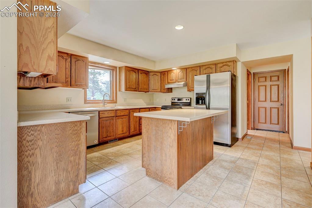 6290 Old Ranch Road Colorado Springs, CO 80908 - Photo 22 of 48 a kitchen with a sink a counter top space and cabinets