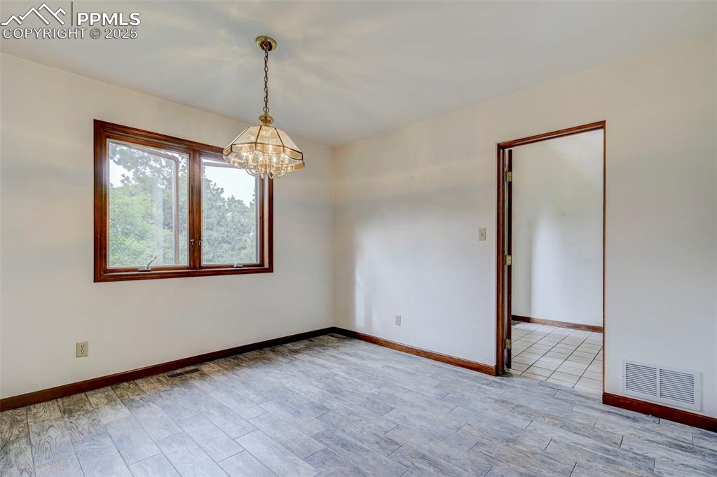 6290 Old Ranch Road Colorado Springs, CO 80908 - Photo 28 of 48 a view of a room with wooden floor chandelier and windows