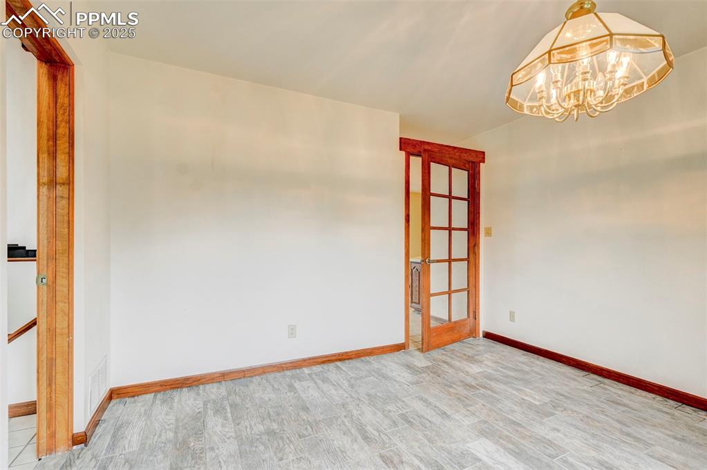 6290 Old Ranch Road Colorado Springs, CO 80908 - Photo 29 of 48 an empty room with wooden floor and windows
