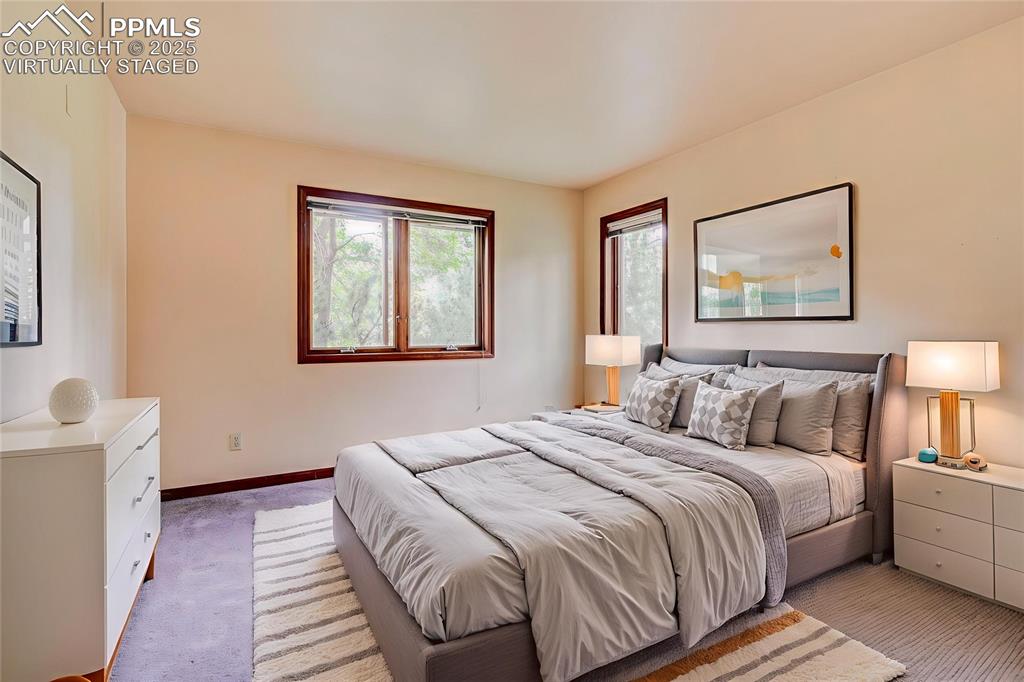 6290 Old Ranch Road Colorado Springs, CO 80908 - Photo 36 of 48 a bedroom with a large bed and a window