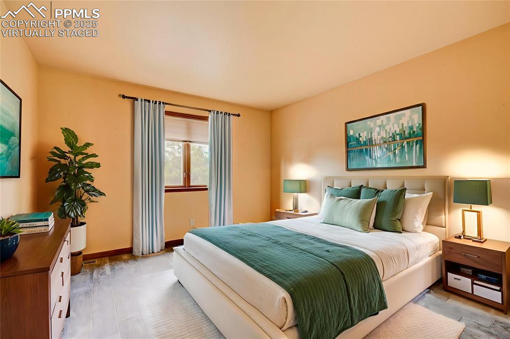 6290 Old Ranch Road Colorado Springs, CO 80908 - Photo 39 of 48 a bedroom with bed and a potted plant