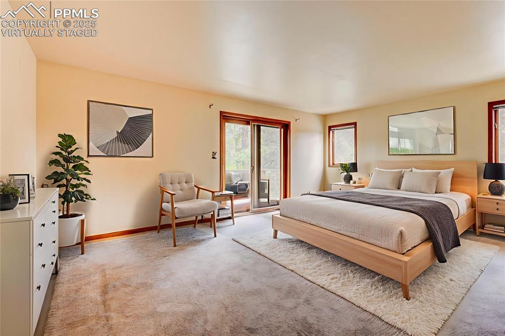 6290 Old Ranch Road Colorado Springs, CO 80908 - Photo 42 of 48 a spacious bedroom with a bed and a couch