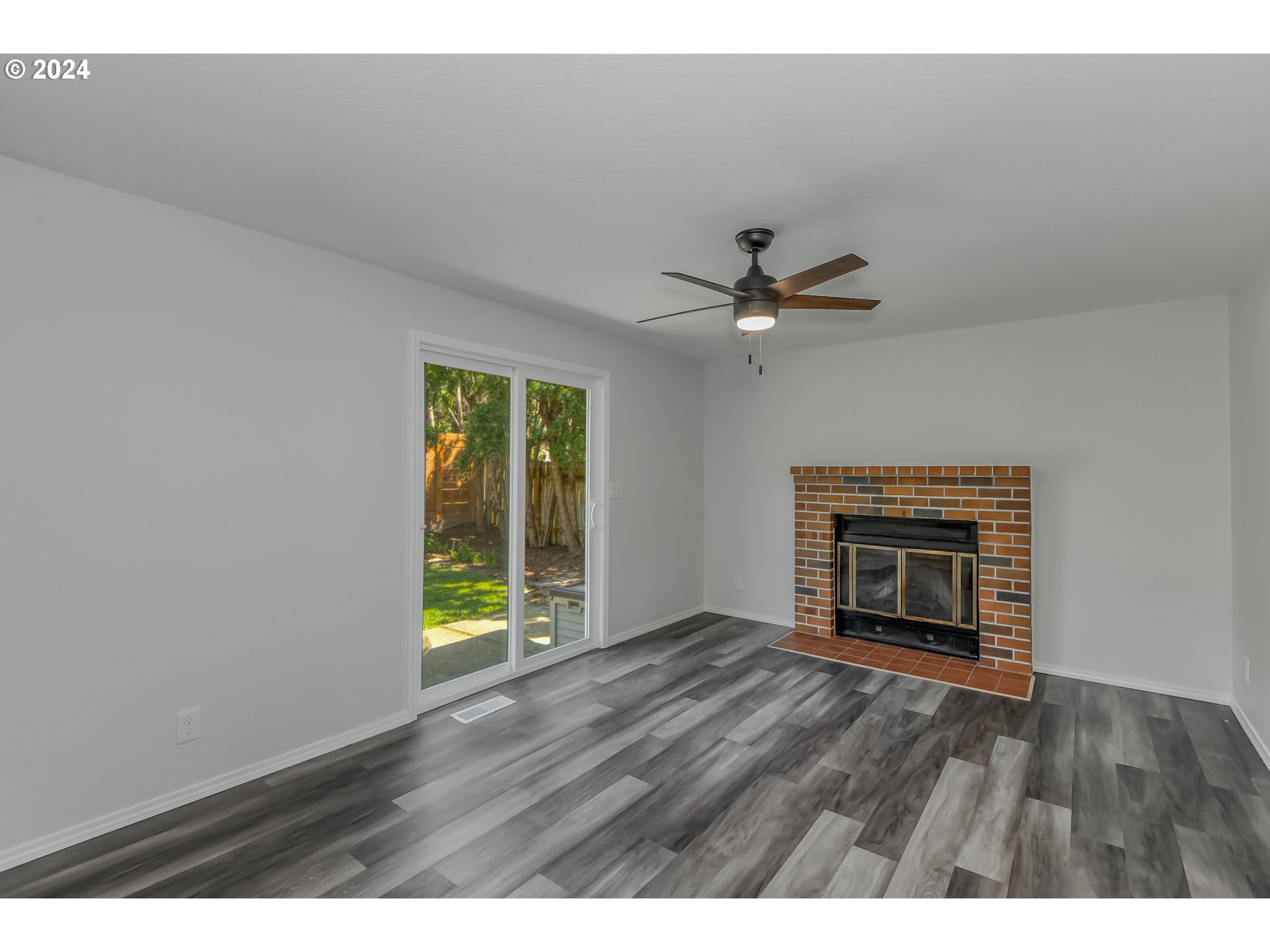 8640 Southwest 133rd Avenue Beaverton, OR 97008 - Photo 12 of 25 a view of an empty room with wooden floor and a window