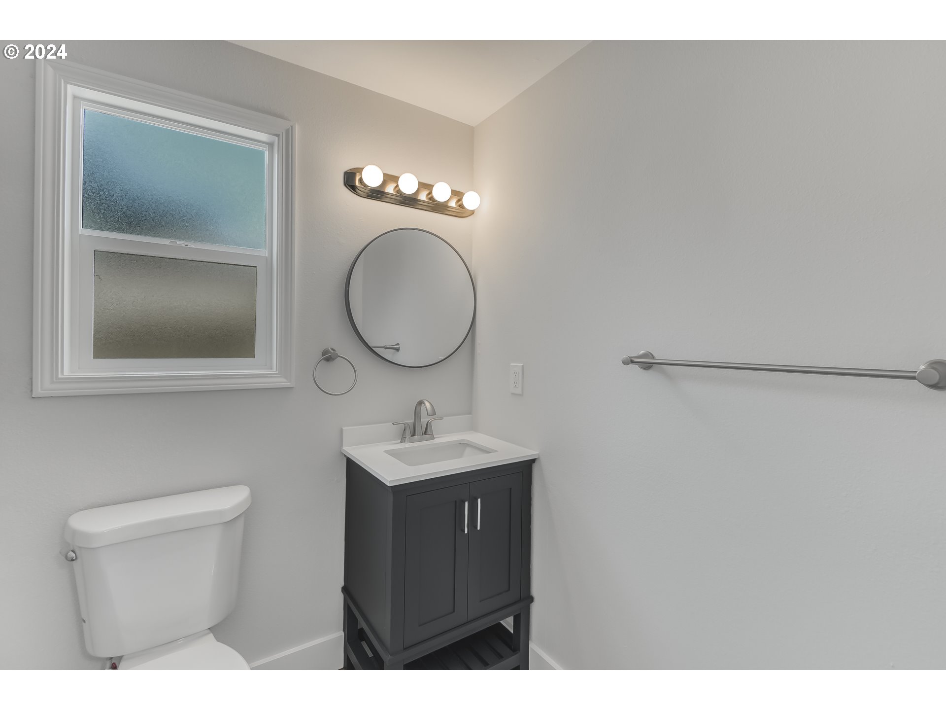 8640 Southwest 133rd Avenue Beaverton, OR 97008 - Photo 21 of 25 a bathroom with a sink a toilet and a mirror