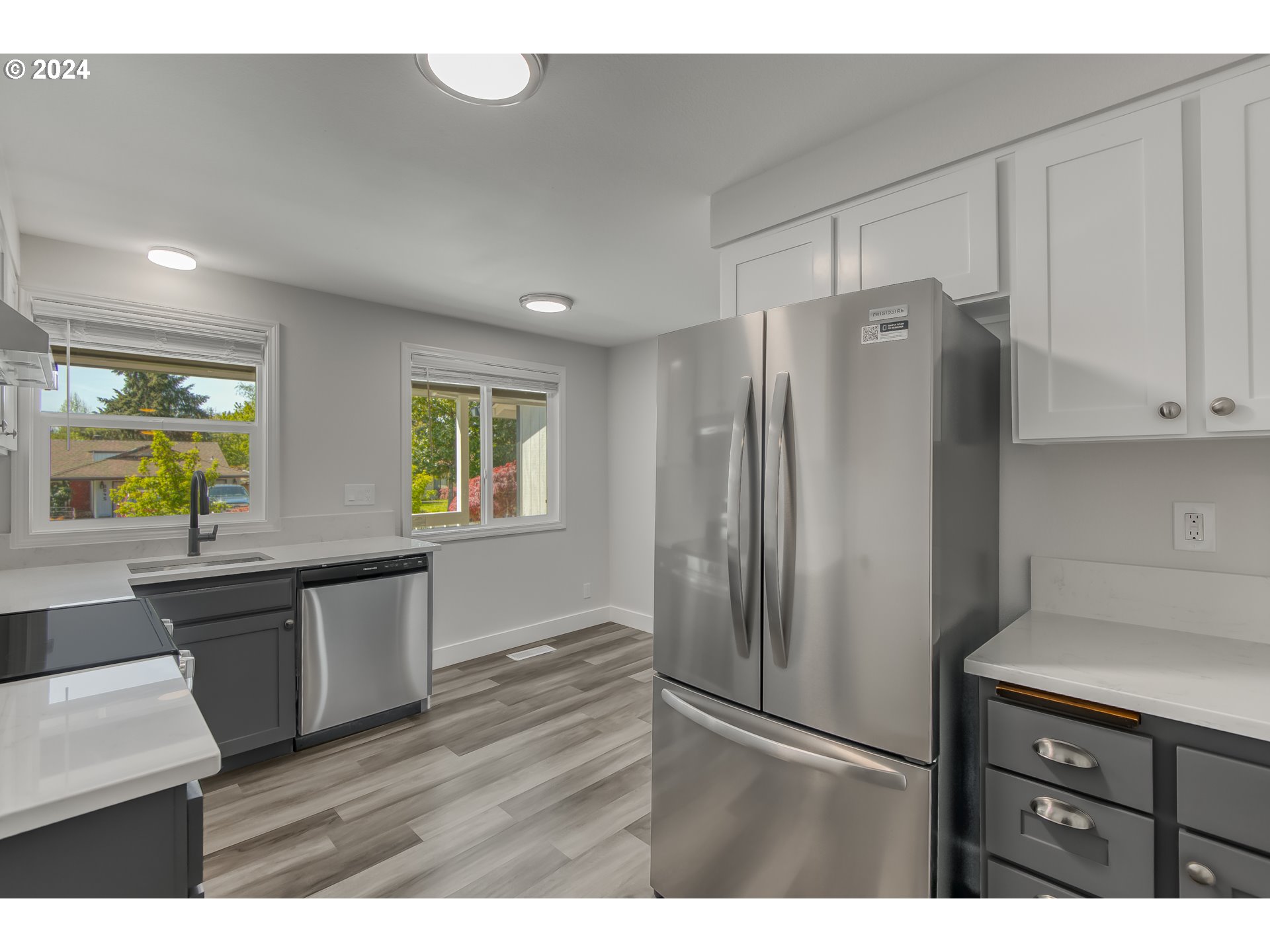 8640 Southwest 133rd Avenue Beaverton, OR 97008 - Photo 8 of 25 a kitchen with stainless steel appliances granite countertop a refrigerator and a sink