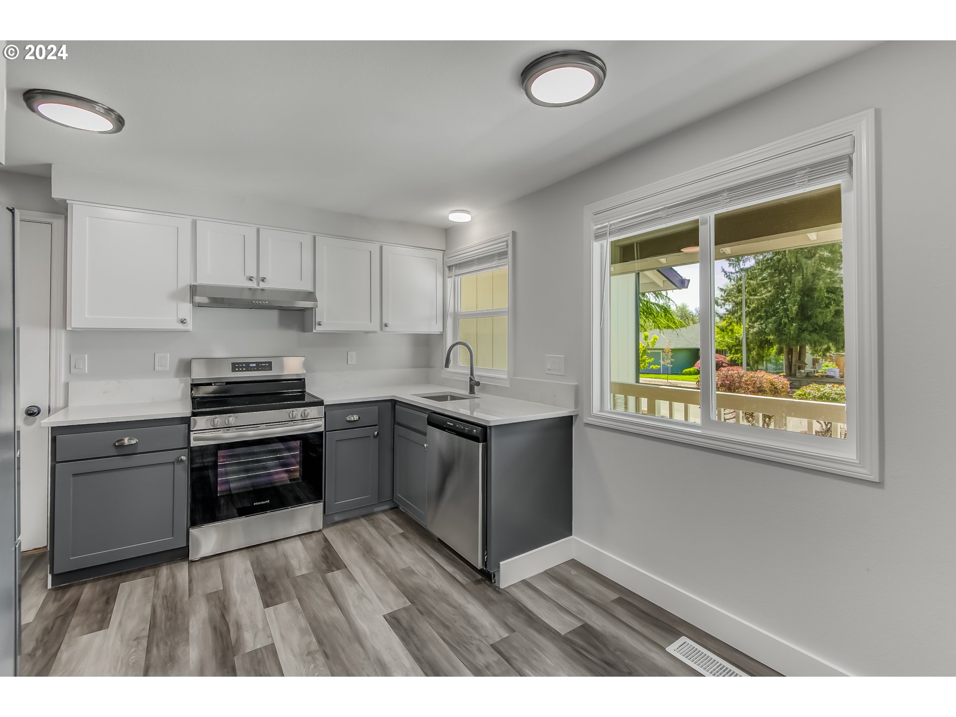 8640 Southwest 133rd Avenue Beaverton, OR 97008 - Photo 9 of 25 a kitchen with granite countertop a stove top oven sink and cabinets
