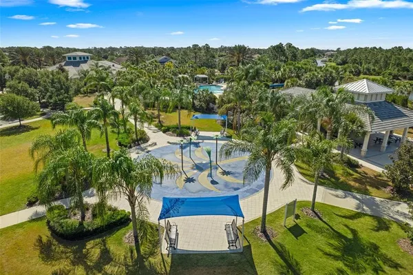 an aerial view of residential houses with outdoor space and trees