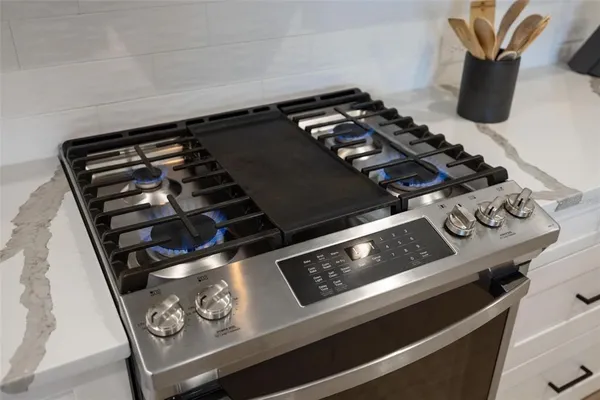 a close up of a stove top oven sitting inside of a kitchen