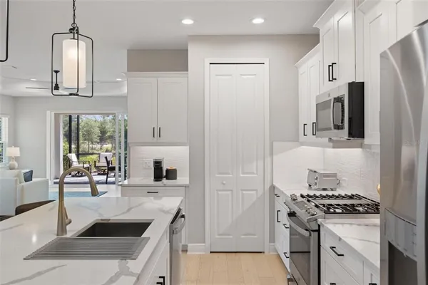 a kitchen with stainless steel appliances a stove a refrigerator and a sink