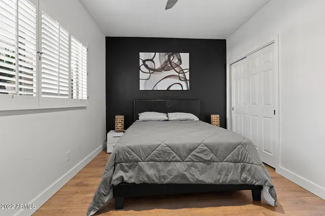 a bedroom with a bed and a window