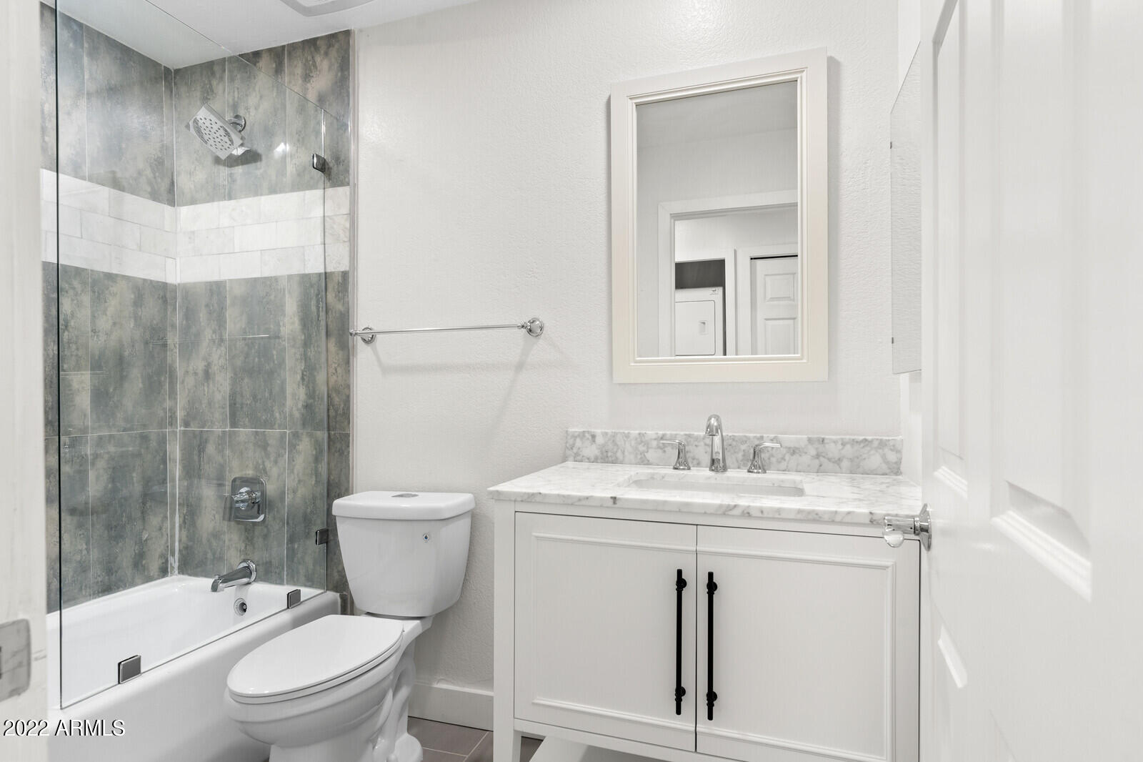 3047 East Rose Lane Phoenix, AZ 85016 - Photo 18 of 27 a bathroom with a sink toilet vanity and shower