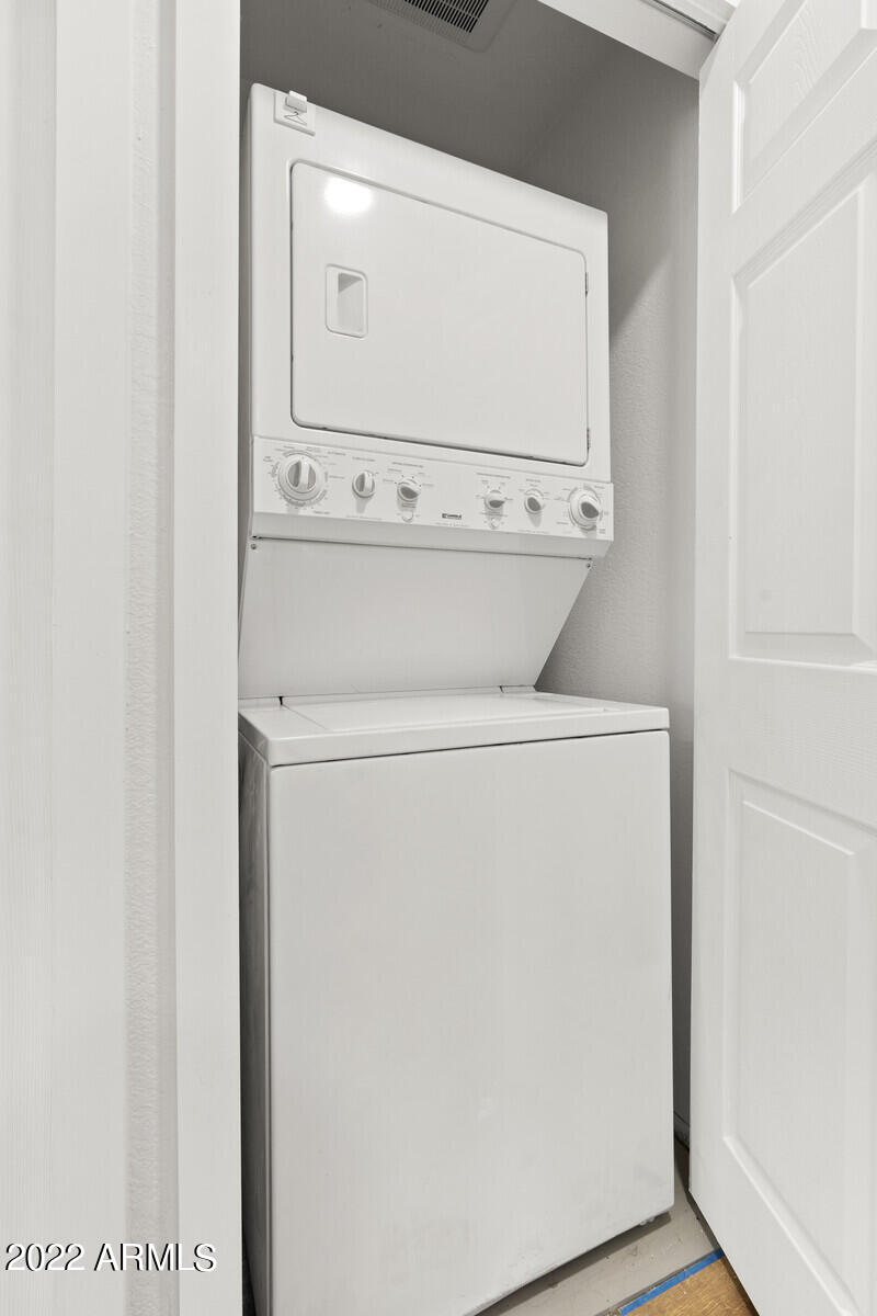 3047 East Rose Lane Phoenix, AZ 85016 - Photo 21 of 27 a close up view of a washer and dryer with wooden floor