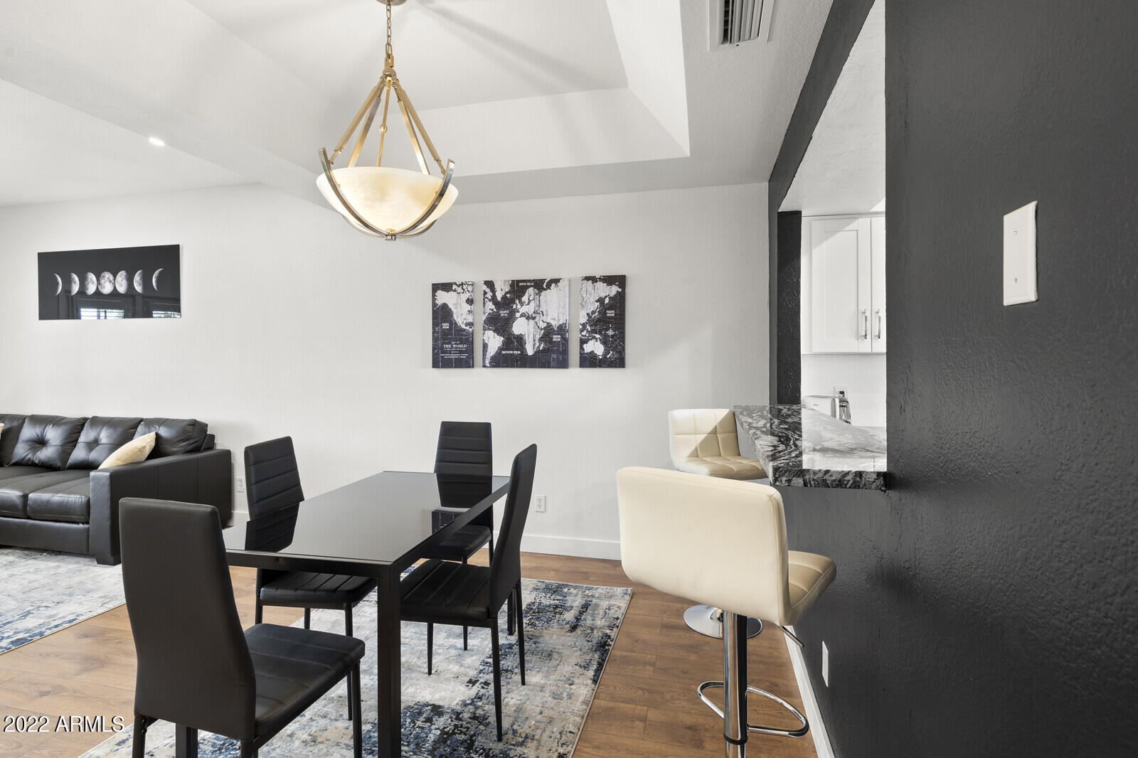 3047 East Rose Lane Phoenix, AZ 85016 - Photo 6 of 27 a view of a dining room with furniture and wooden floor