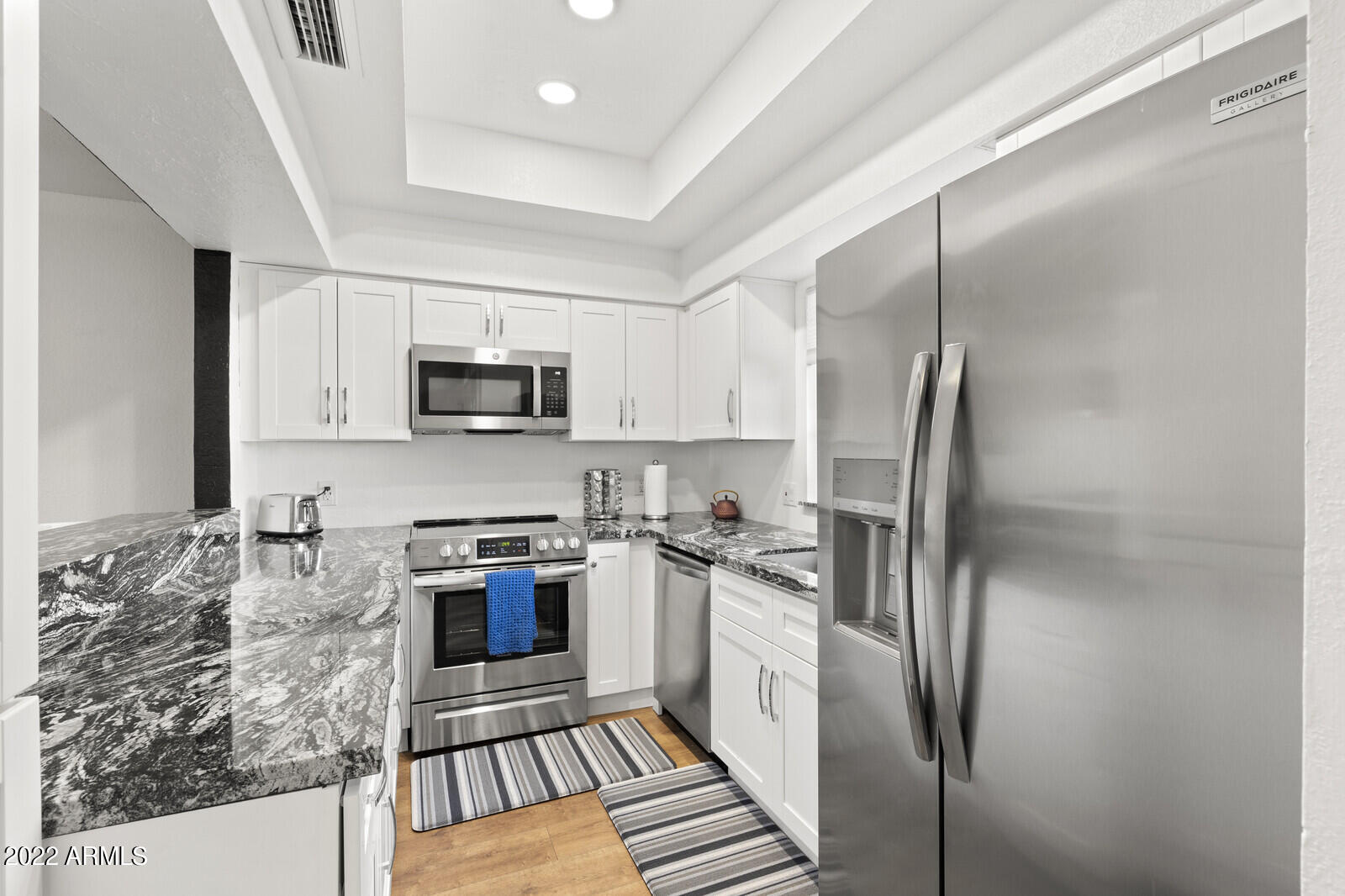 3047 East Rose Lane Phoenix, AZ 85016 - Photo 10 of 27 a kitchen with stainless steel appliances granite countertop a stove a refrigerator and a sink