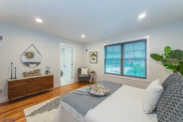 a bedroom with furniture and a window