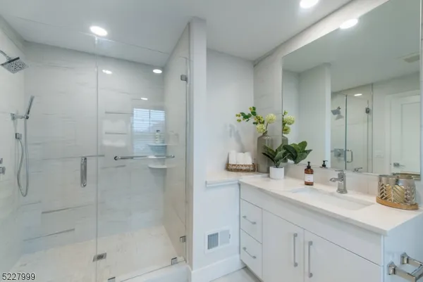a bathroom with a shower sink and mirror