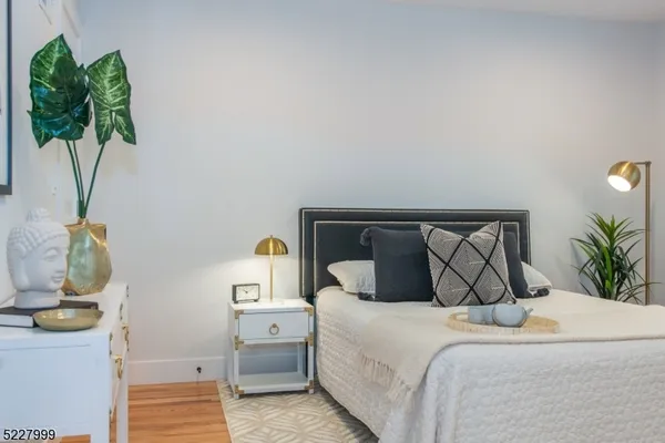 a bedroom with a bed and a plant