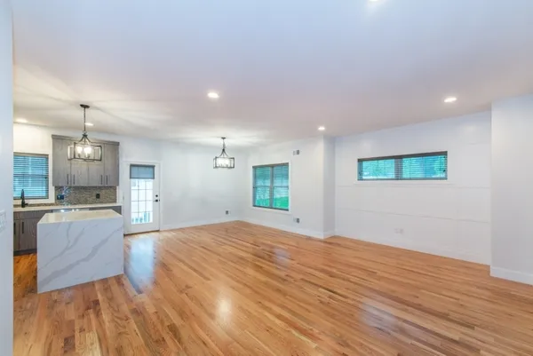 a view of a kitchen with a sink and a refrigerator