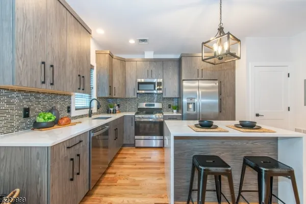 a kitchen with stainless steel appliances granite countertop a sink counter space and cabinets