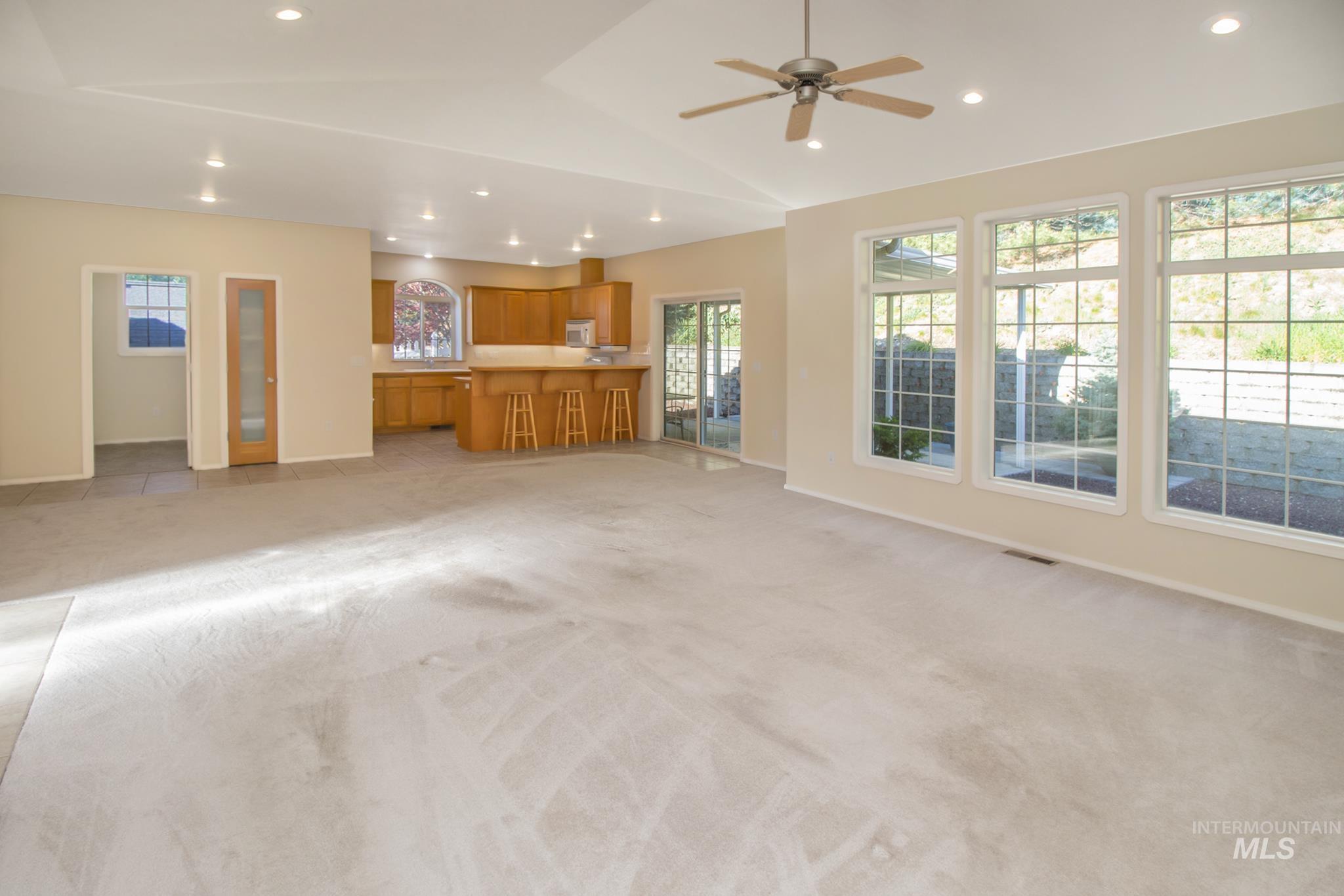 2133 13th Street Lewiston, ID 83501 - Photo 12 of 38 Open-concept living space featuring light-toned carpeting, recessed ceiling lighting, and a ceiling fan