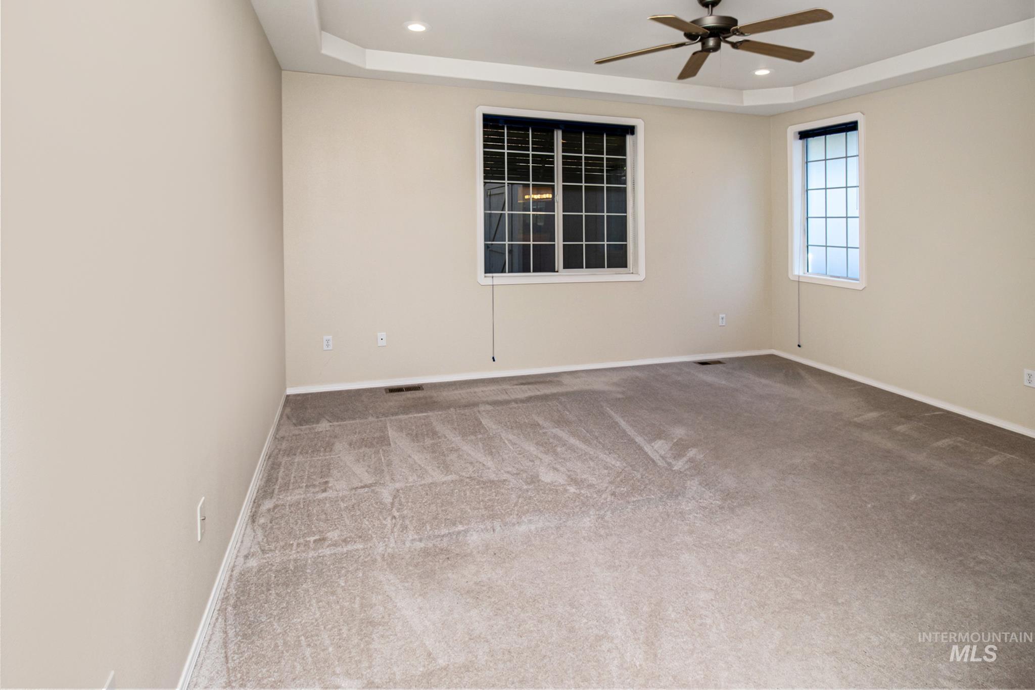 2133 13th Street Lewiston, ID 83501 - Photo 14 of 38 Spacious room featuring neutral carpeting, a tray ceiling with recessed lighting, and a ceiling fan