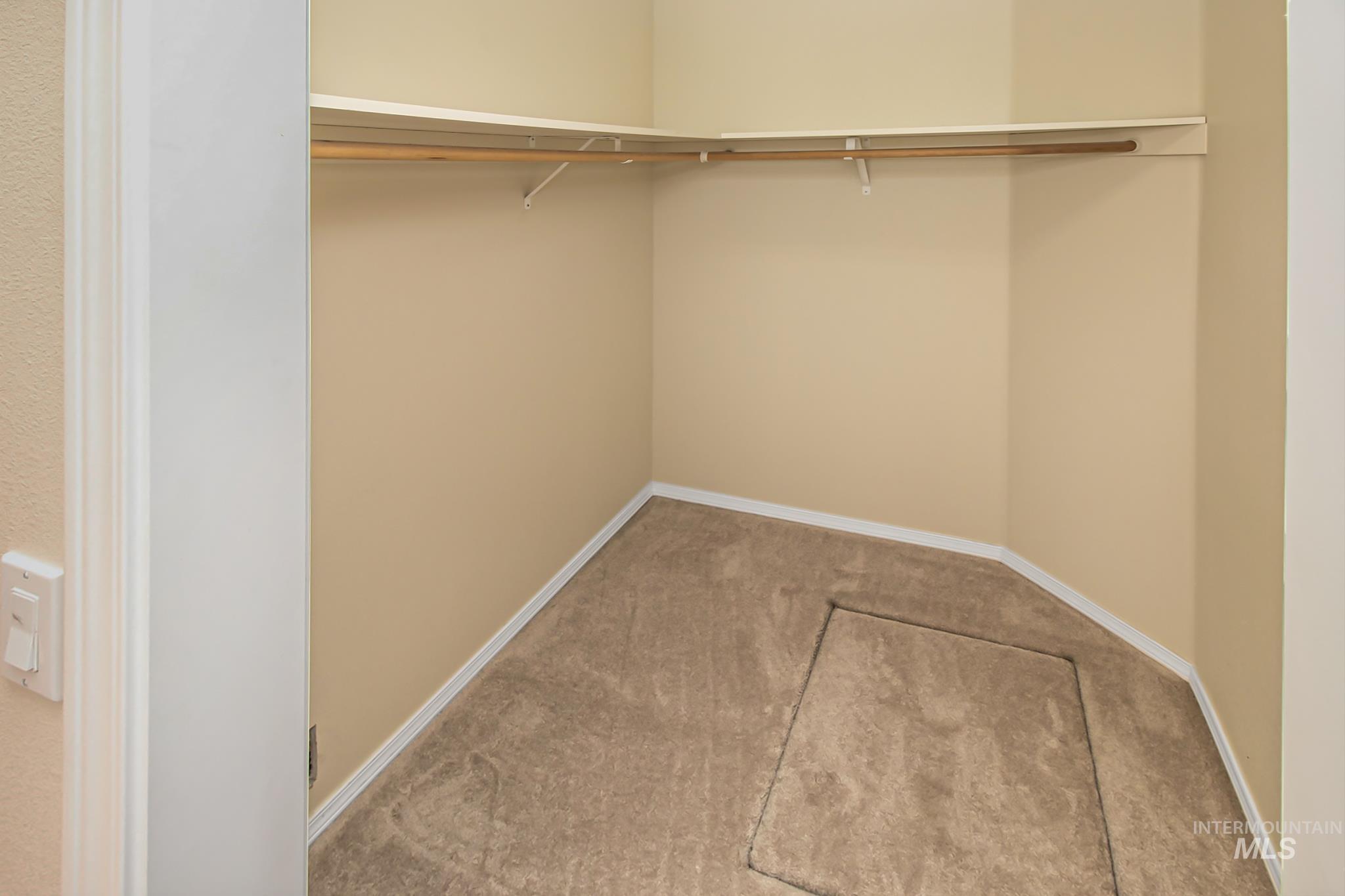 2133 13th Street Lewiston, ID 83501 - Photo 17 of 38 Carpeted closet with corner-mounted shelving and clothing rod