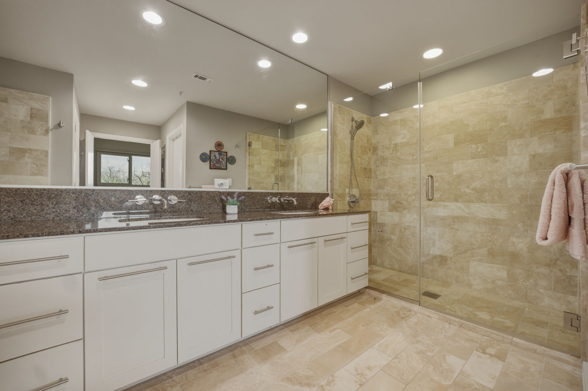 1600 Barton Springs Road, Unit 4305 Austin, TX 78704 - Photo 12 of 26 a bathroom with a granite countertop sink a mirror and a shower