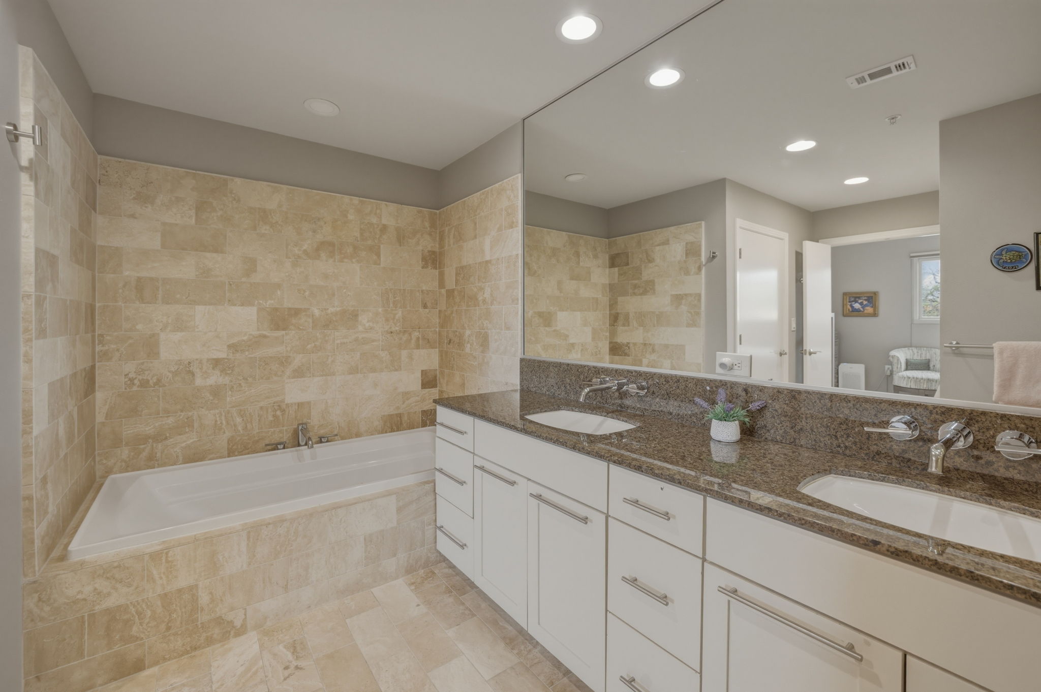 1600 Barton Springs Road, Unit 4305 Austin, TX 78704 - Photo 13 of 26 a bathroom with a granite countertop sink a mirror a bathtub and next to a shower