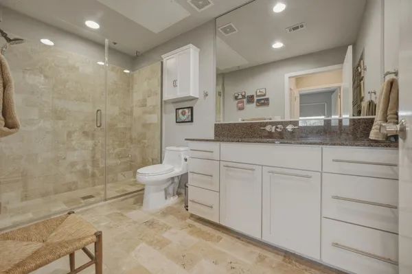 a white toilet sitting next to a white walls