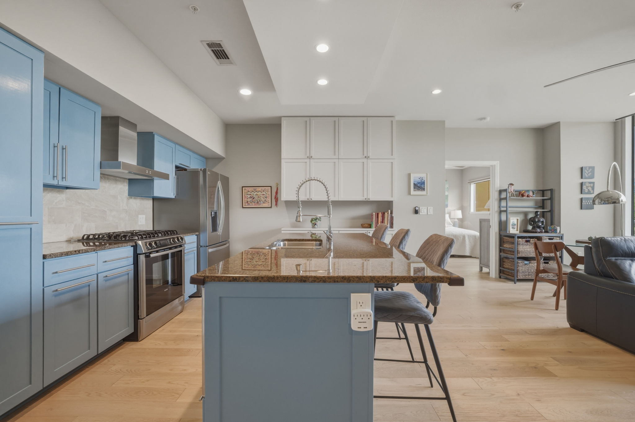 1600 Barton Springs Road, Unit 4305 Austin, TX 78704 - Photo 3 of 26 a large kitchen with stainless steel appliances granite countertop a stove a sink a dining table and chairs