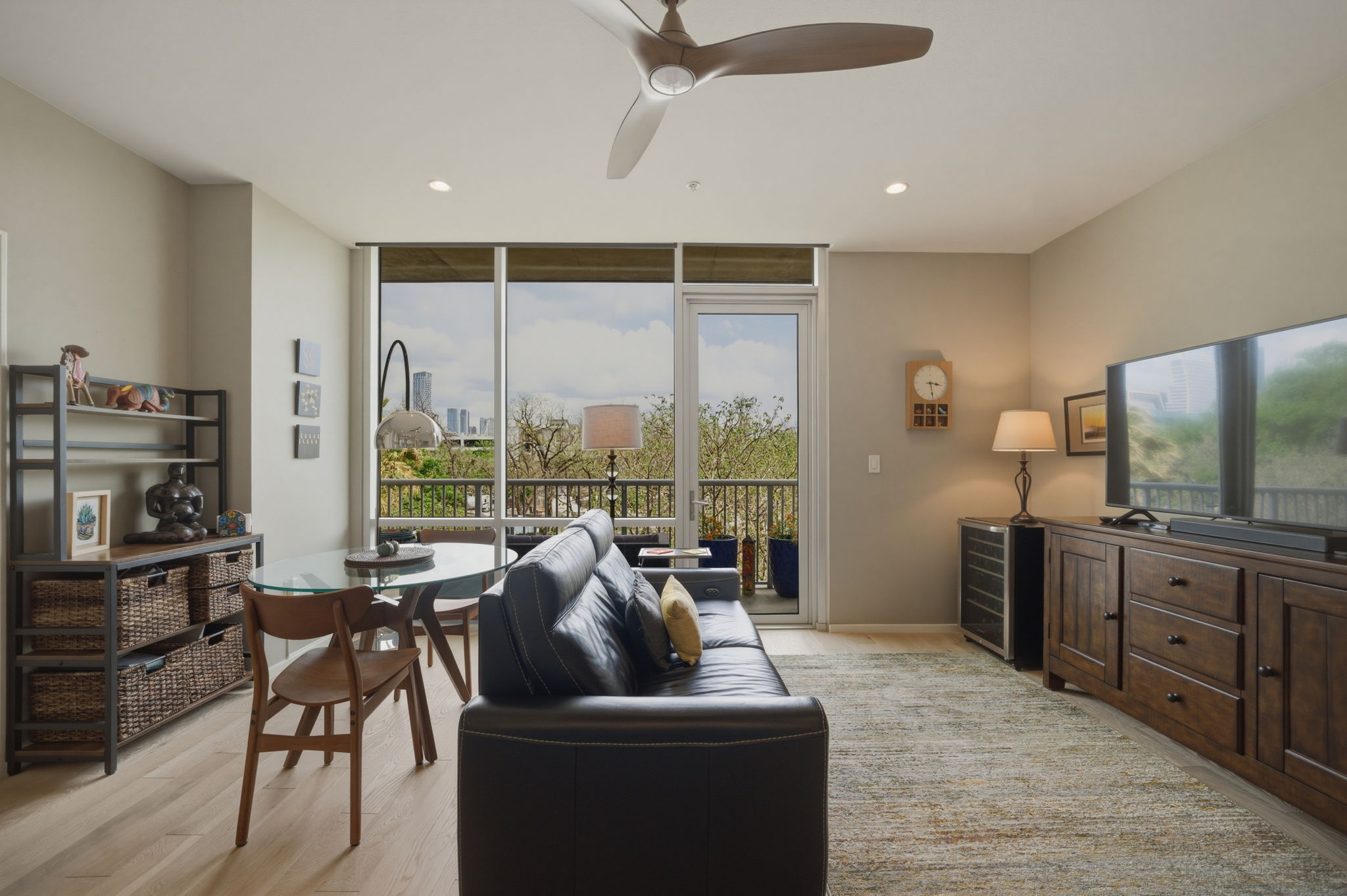1600 Barton Springs Road, Unit 4305 Austin, TX 78704 - Photo 8 of 26 a living room with furniture a flat screen tv and a floor to ceiling window