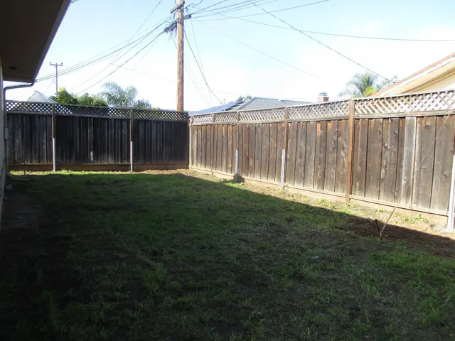 a backyard with wooden fence