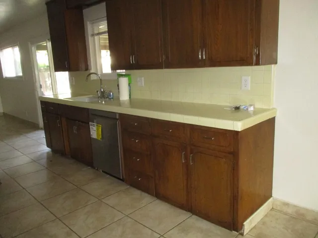 a kitchen with a sink and cabinets