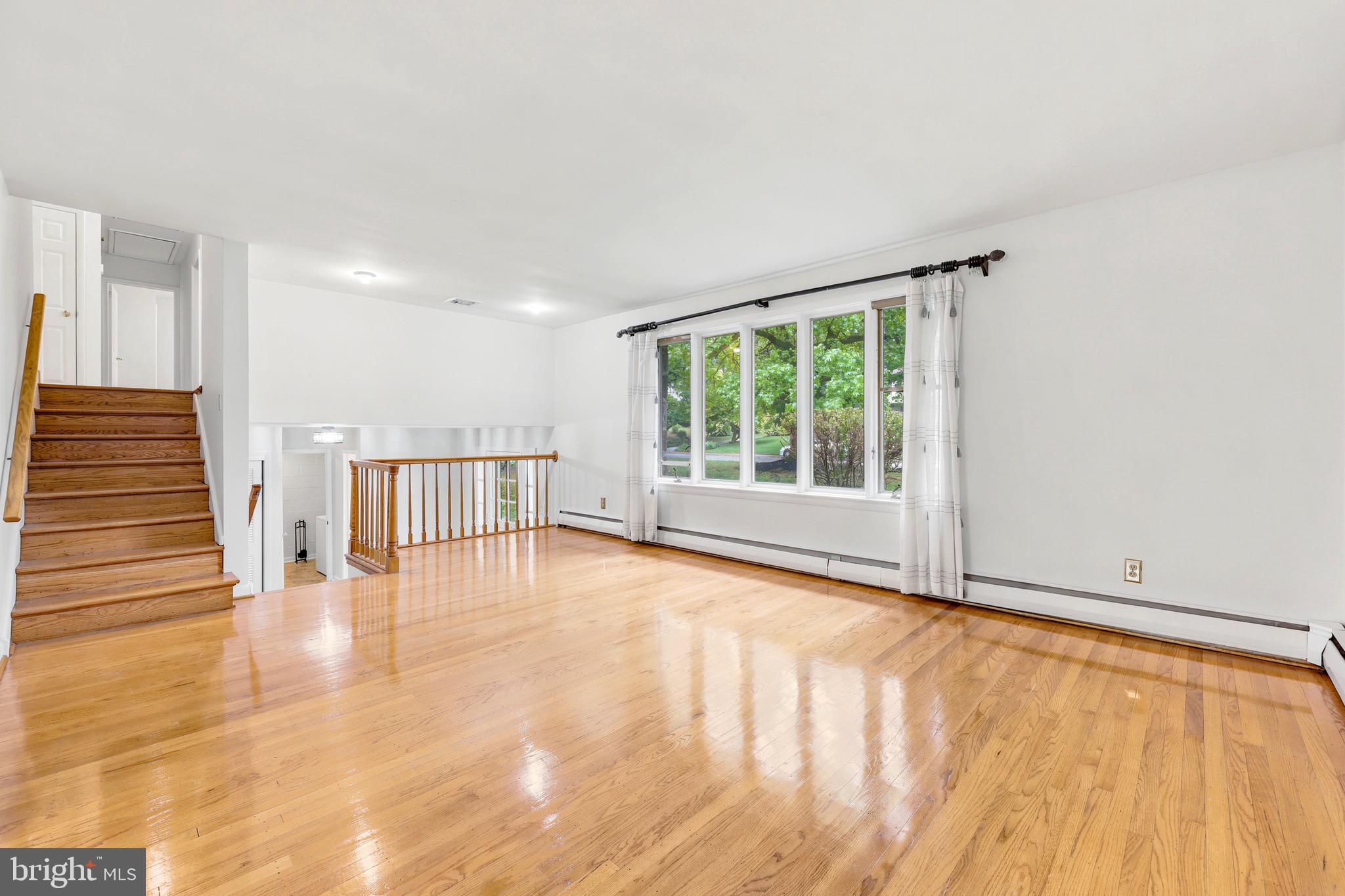 412 Yorkshire Road Bryn Mawr, PA 19010 - Photo 6 of 25 a view of an empty room with wooden floor and a window