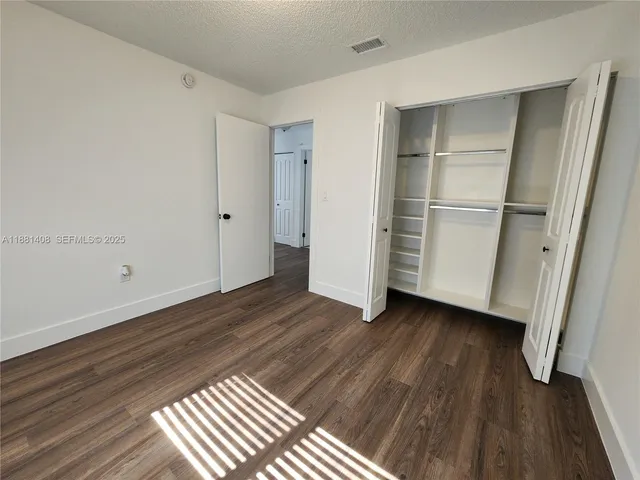 a view of a room with wooden floor