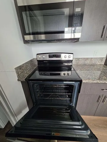 a stove top oven sitting inside of a kitchen